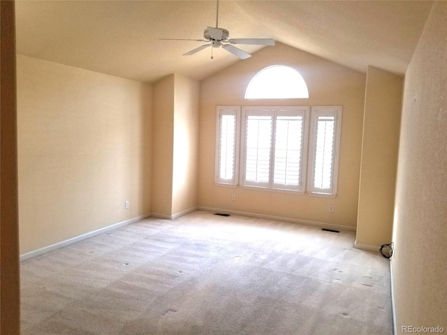 carpeted empty room with ceiling fan and vaulted ceiling