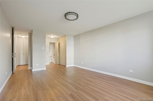 empty room with light hardwood / wood-style floors