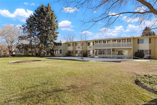 rear view of house featuring a lawn