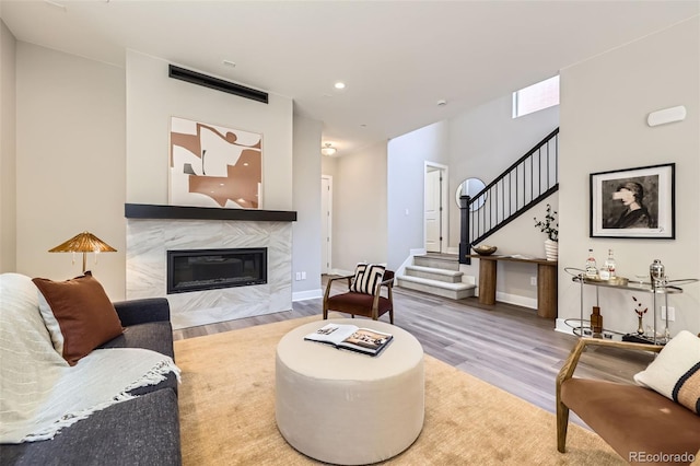 858 Promenade Dr, Superior, CO 80027 - living area with wood finished floors, stairway, a fireplace, recessed lighting, and baseboards