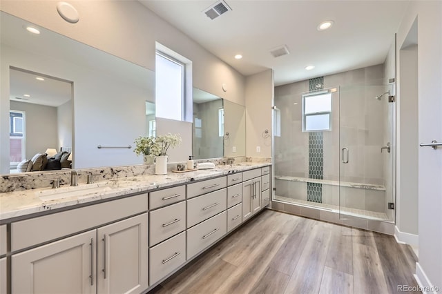 858 Promenade Dr, Superior, CO 80027 - full bathroom with double vanity, a shower stall, wood finished floors, recessed lighting, and baseboards
