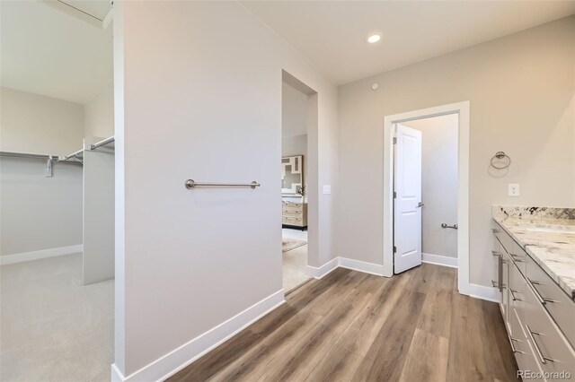 858 Promenade Dr, Superior, CO 80027 - full bathroom with vanity, baseboards, wood finished floors, a spacious closet, and recessed lighting