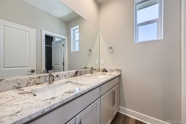 858 Promenade Dr, Superior, CO 80027 - bathroom featuring baseboards, double vanity, and wood finished floors