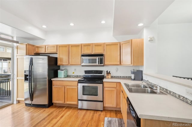 kitchen with light brown cabinetry, sink, appliances with stainless steel finishes, and light hardwood / wood-style flooring