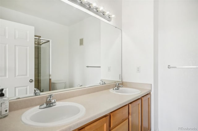 bathroom with toilet, an enclosed shower, and vanity