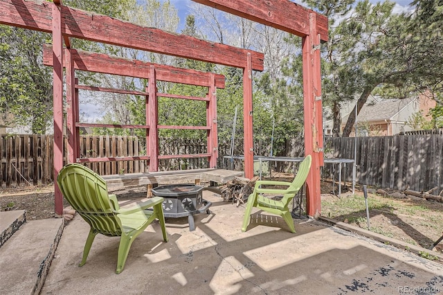 view of patio / terrace with an outdoor fire pit, a pergola, and a fenced backyard