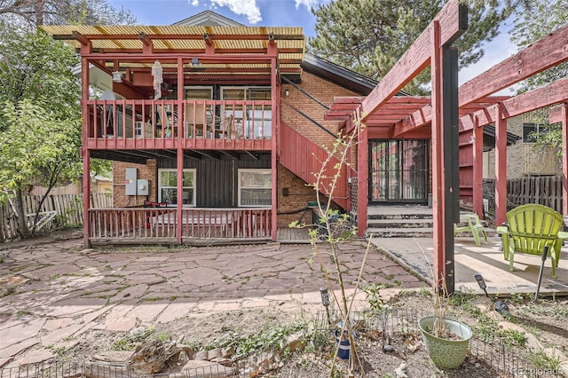 back of property featuring a pergola, a patio area, fence, and brick siding