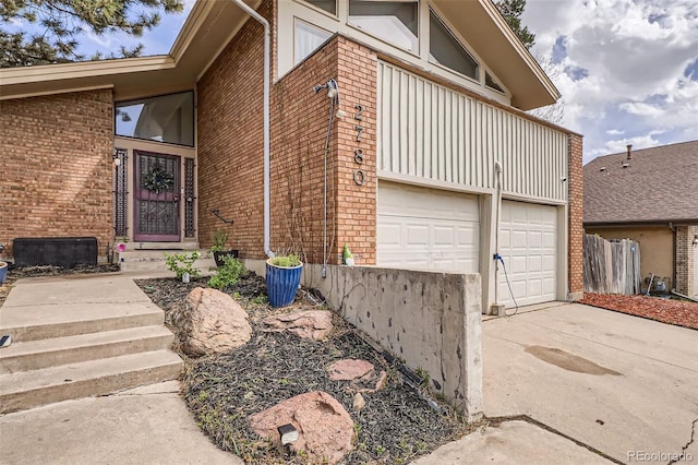 view of side of home with brick siding and driveway