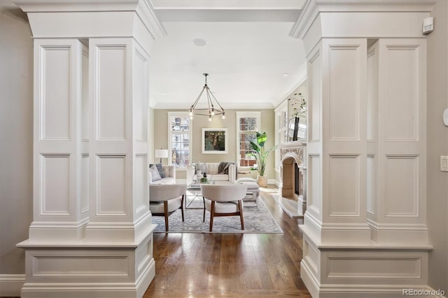 interior space with dark wood-style floors, baseboards, a fireplace, and ornamental molding