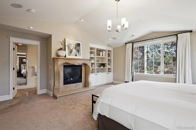 carpeted bedroom featuring a chandelier, vaulted ceiling, baseboards, and a premium fireplace