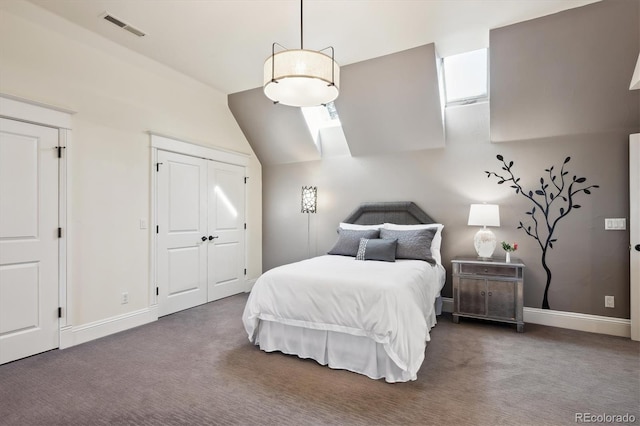 bedroom with dark carpet, visible vents, and baseboards