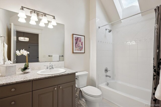 full bathroom featuring a skylight, shower / bath combo, vanity, and toilet