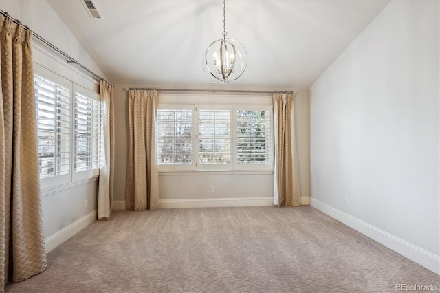 carpeted spare room with baseboards, visible vents, a chandelier, and vaulted ceiling