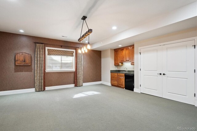 kitchen with brown cabinetry, dishwasher, decorative light fixtures, carpet, and recessed lighting