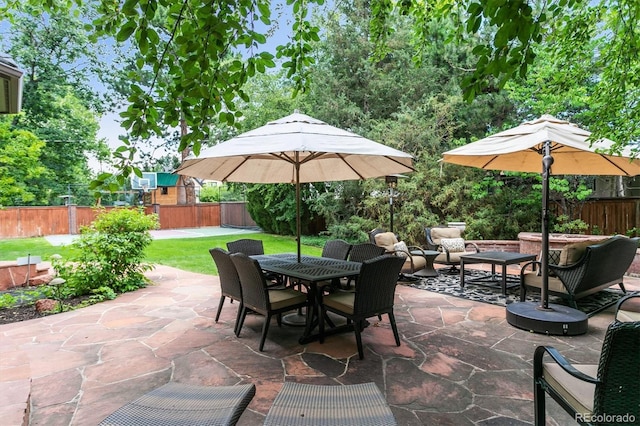 view of patio with a fenced backyard and outdoor dining area