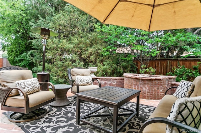 view of patio / terrace featuring a fire pit and fence