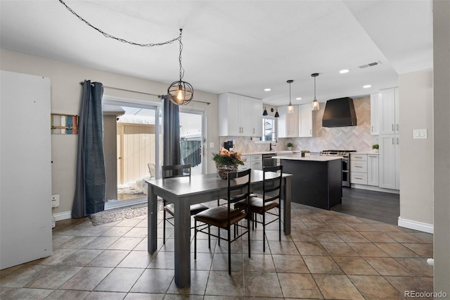 tiled dining room featuring baseboards, visible vents, and recessed lighting