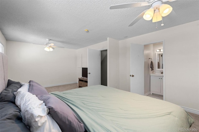 bedroom featuring ceiling fan, a textured ceiling, connected bathroom, light carpet, and baseboards