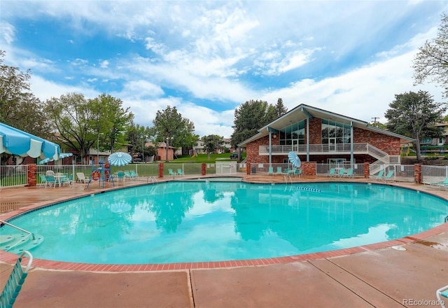 community pool featuring a patio area and fence