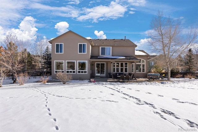 view of snow covered rear of property