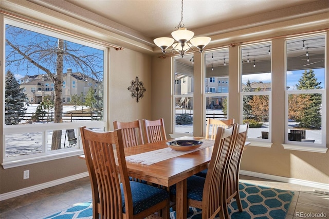 tiled dining area with a notable chandelier