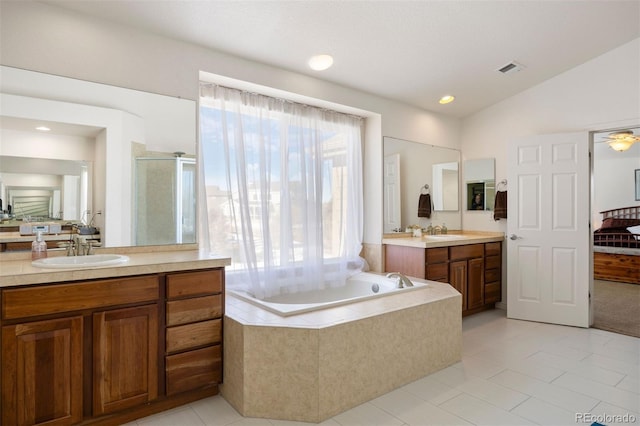 bathroom with lofted ceiling, vanity, tile patterned floors, and plus walk in shower