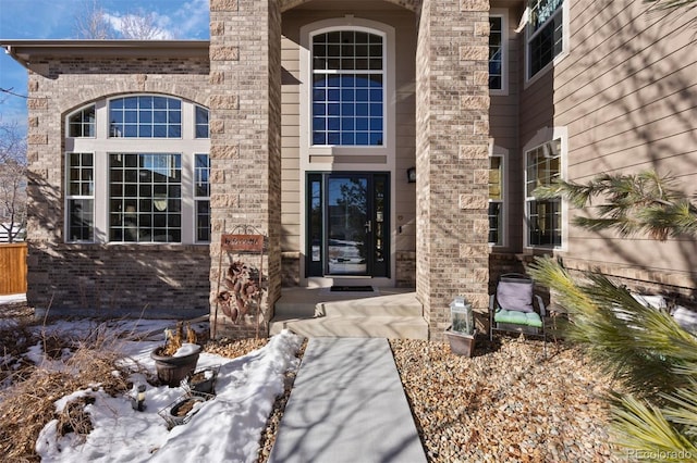 view of snow covered property entrance