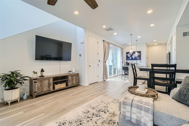 12345 Festival Ln, Thornton, CO 80241 - living area featuring light wood-style floors, ceiling fan, and recessed lighting