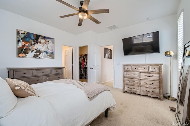 12345 Festival Ln, Thornton, CO 80241 - bedroom with light colored carpet, a walk in closet, ceiling fan, and a closet