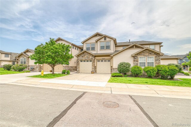 23070 York Ave, Parker, CO 80138 - view of front of property with stone siding, concrete driveway, and a garage