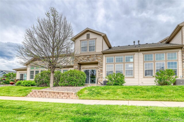 23070 York Ave, Parker, CO 80138 - traditional-style home featuring stone siding and a front yard