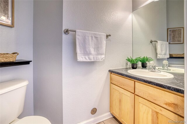 23070 York Ave, Parker, CO 80138 - half bathroom with vanity, toilet, tile patterned floors, and a textured wall