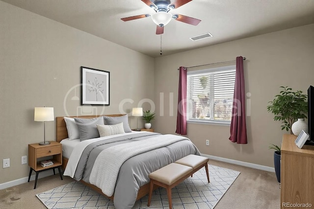 bedroom featuring visible vents, light colored carpet, and baseboards