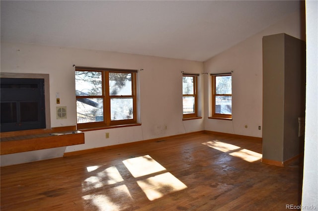 unfurnished living room with lofted ceiling and dark hardwood / wood-style floors