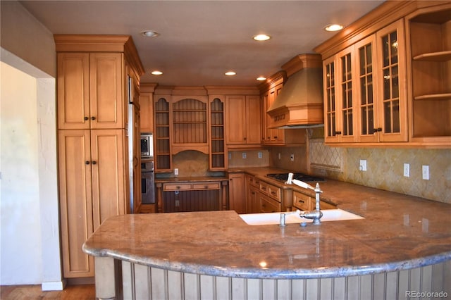 kitchen with sink, kitchen peninsula, custom range hood, stainless steel appliances, and backsplash