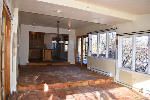 unfurnished sunroom with a notable chandelier and baseboard heating