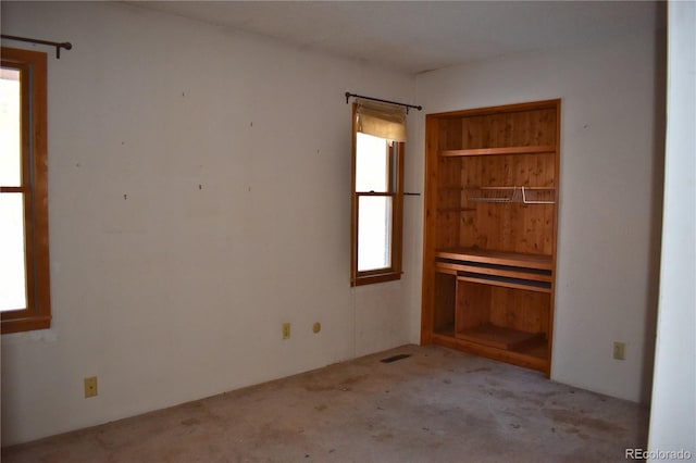 unfurnished bedroom with multiple windows and light carpet