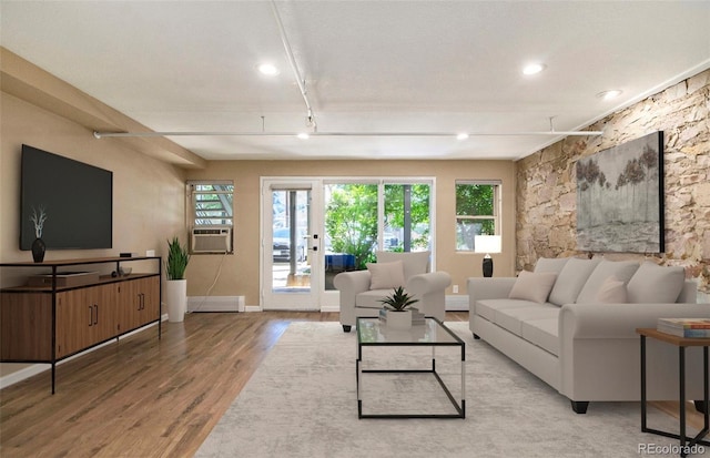 living area featuring a baseboard heating unit, wood finished floors, recessed lighting, cooling unit, and baseboards