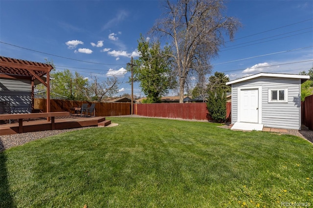 view of yard featuring a shed, an outdoor structure, and a wooden deck