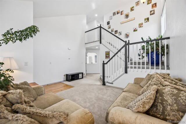 10530 Mount Columbia Pl, Parker, CO 80138 - living area with a high ceiling, carpet flooring, stairway, recessed lighting, and arched walkways