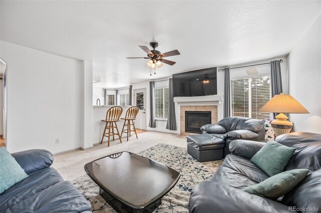 10530 Mount Columbia Pl, Parker, CO 80138 - living area featuring ceiling fan, a fireplace, and light colored carpet