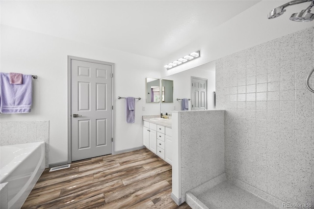 10530 Mount Columbia Pl, Parker, CO 80138 - full bathroom with vanity, walk in shower, a bath, and wood finished floors