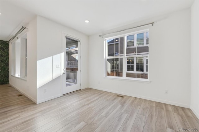 unfurnished room with light hardwood / wood-style floors