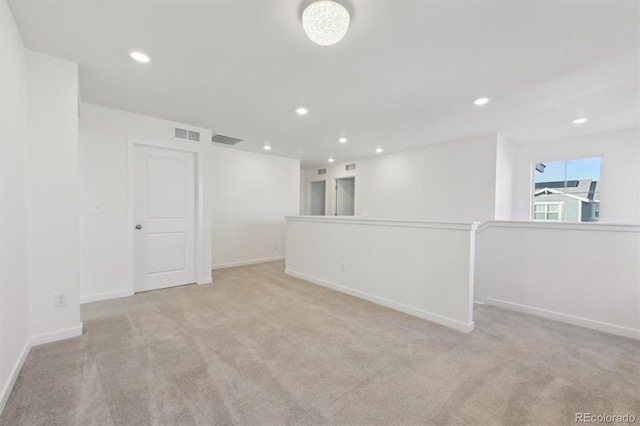 unfurnished room featuring light colored carpet