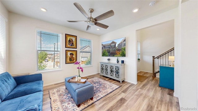 14074 Jackson St, Thornton, CO 80602 - living area featuring light wood-style floors, ceiling fan, stairs, and recessed lighting