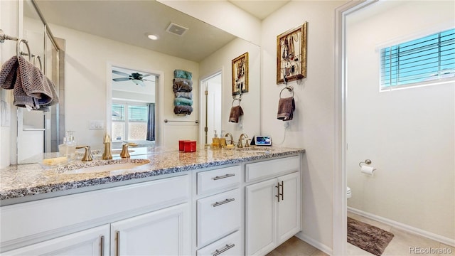 14074 Jackson St, Thornton, CO 80602 - full bath featuring double vanity, a ceiling fan, and tile patterned flooring