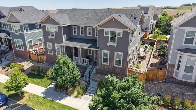 14074 Jackson St, Thornton, CO 80602 - view of front of home featuring stairs, a residential view, and a shingled roof