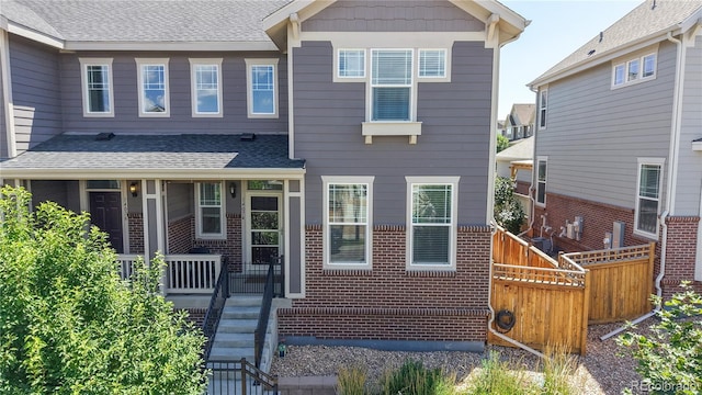14074 Jackson St, Thornton, CO 80602 - view of front facade featuring roof with shingles and brick siding