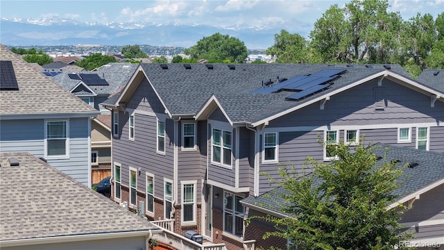 14074 Jackson St, Thornton, CO 80602 - view of home's exterior with solar panels and roof with shingles