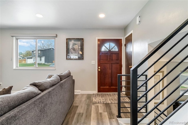 10550 Routt St, Westminster, CO 80021 - entrance foyer with baseboards, a wealth of natural light, stairway, and wood finished floors